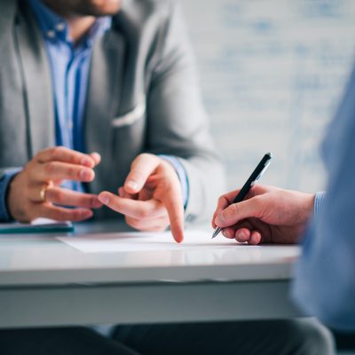 Business consultant and customer on a meeting in the office, signing contract.